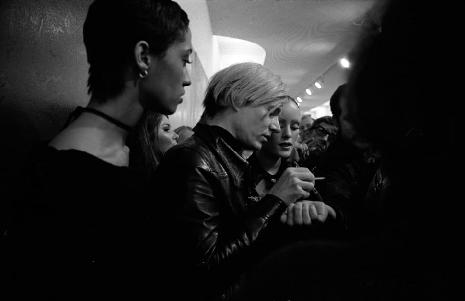 Warhol signing autographs